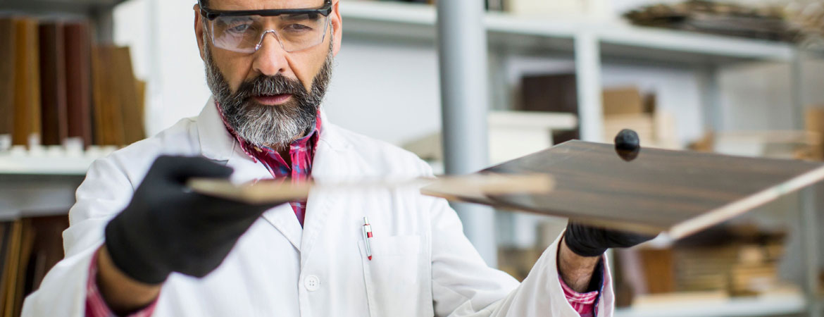 A person holding tiles to test quality of tiles